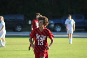 Boy running and playing soccer